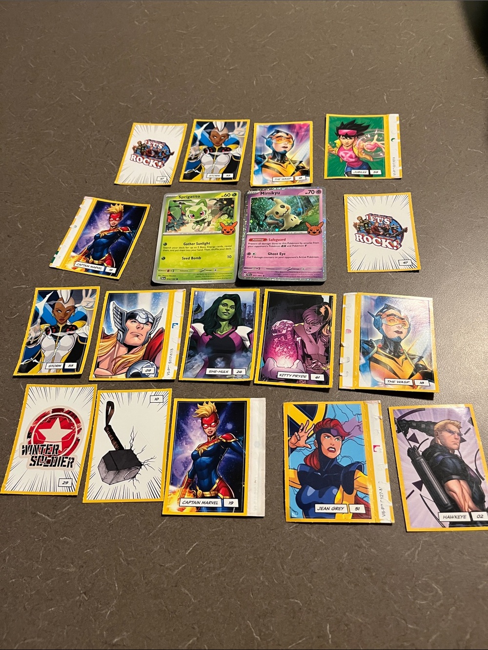 2 Pokemon cards and random Marvel stickers